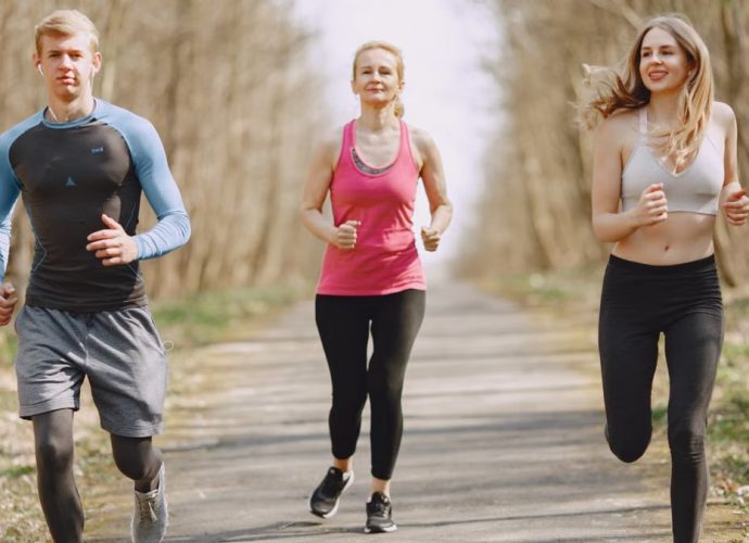 Three adults jogging on a park path, embracing a healthy and active lifestyle.