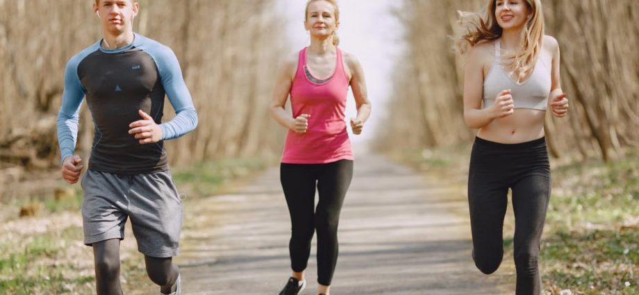 Three adults jogging on a park path, embracing a healthy and active lifestyle.